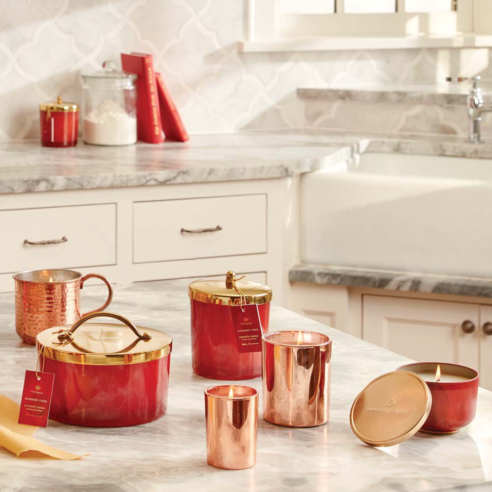 Thymes Simmered Cider Harvest Red 4-Wick Candle on kitchen counter with other Thymes Simmered Cider Red Harvest Candles image number 2